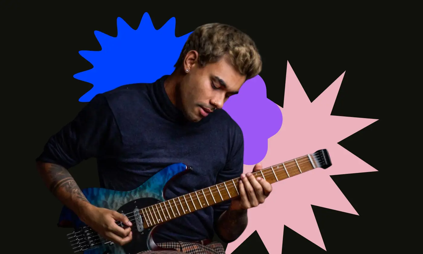 Manuel Gardner Fernandes, a musician and content creator, plays electric guitar against a colorful background
