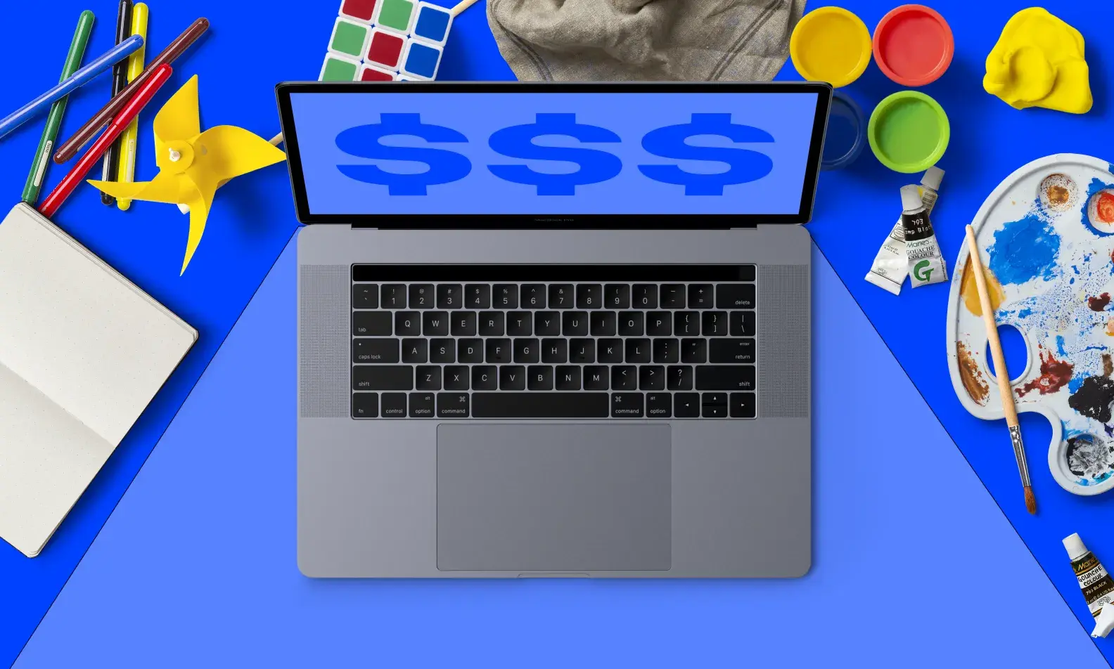 Image of laptop computer with paints and other creative tools