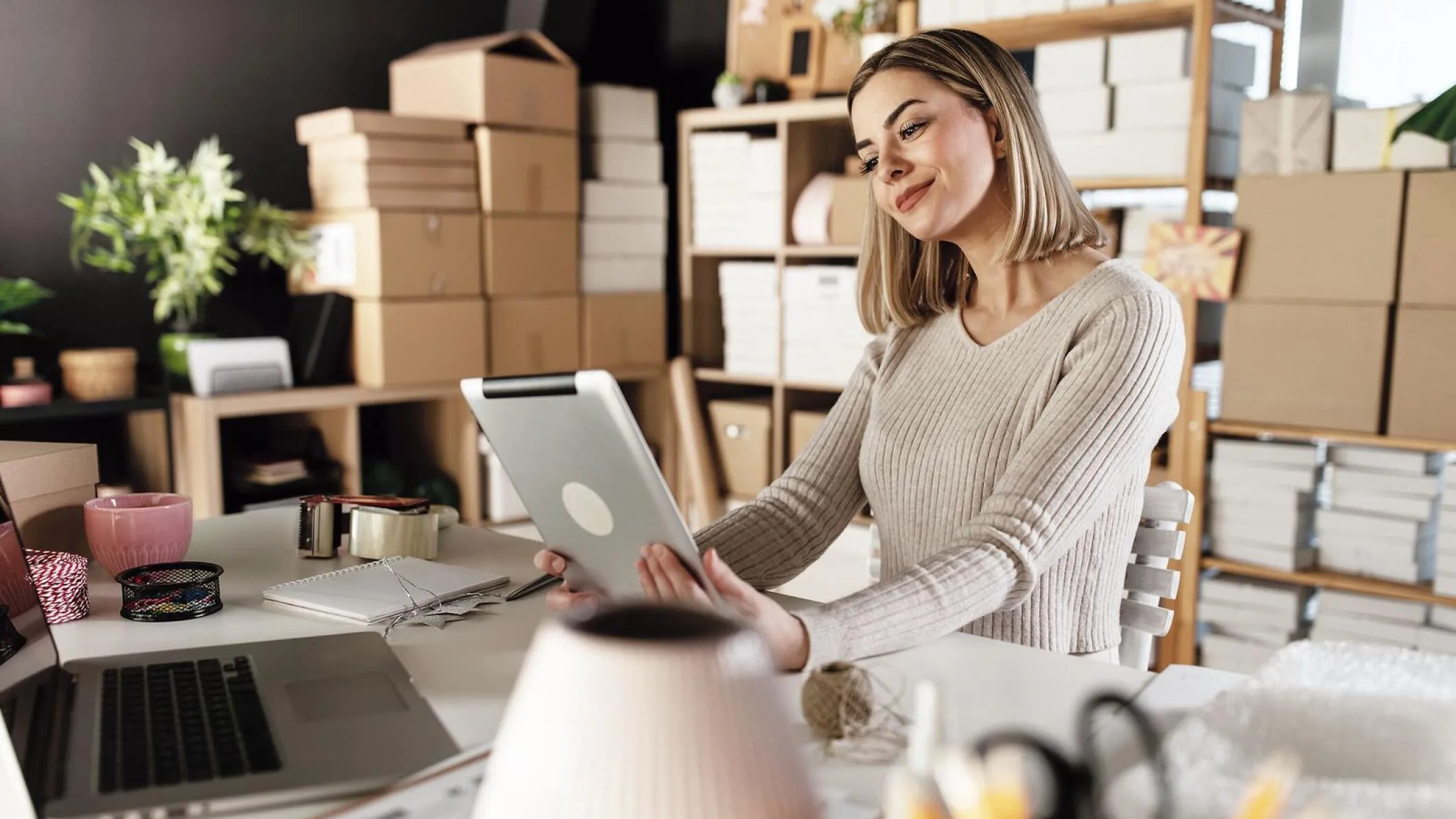 Woman in office looking at tablet